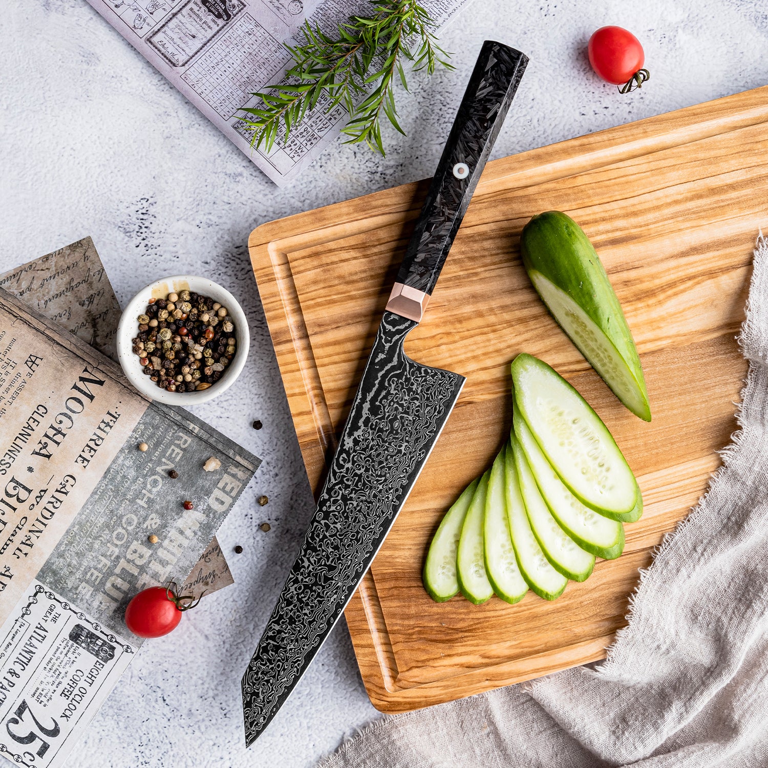 Chef's knife on a wooden cutting board with sliced green apples and peppercorns.