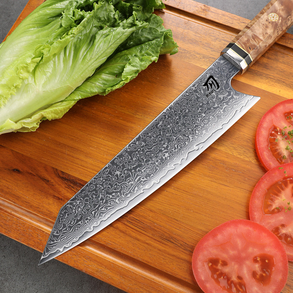 Damascus knife on a wooden cutting board with lettuce and tomatoes